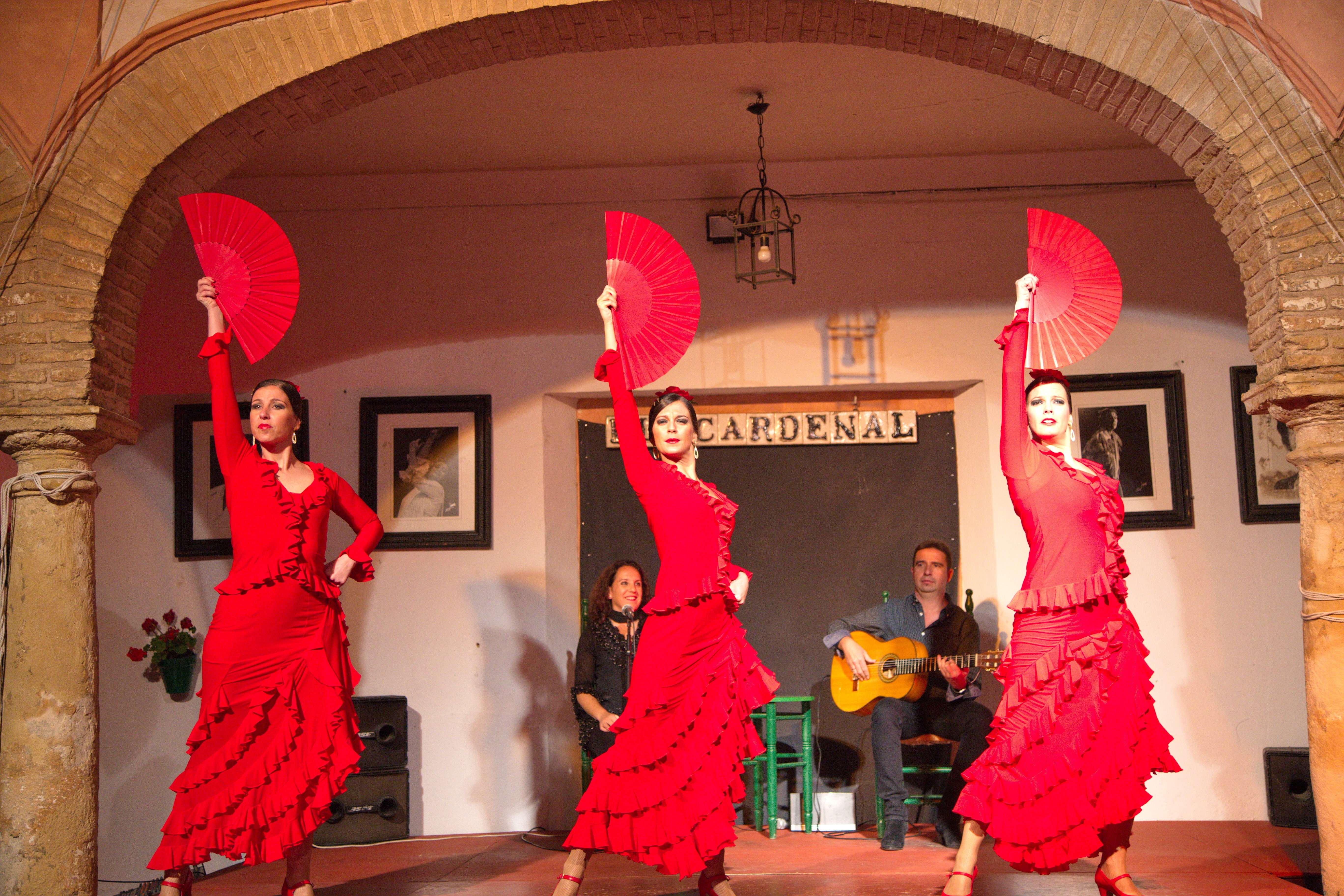 Three women in red at a flamenco show