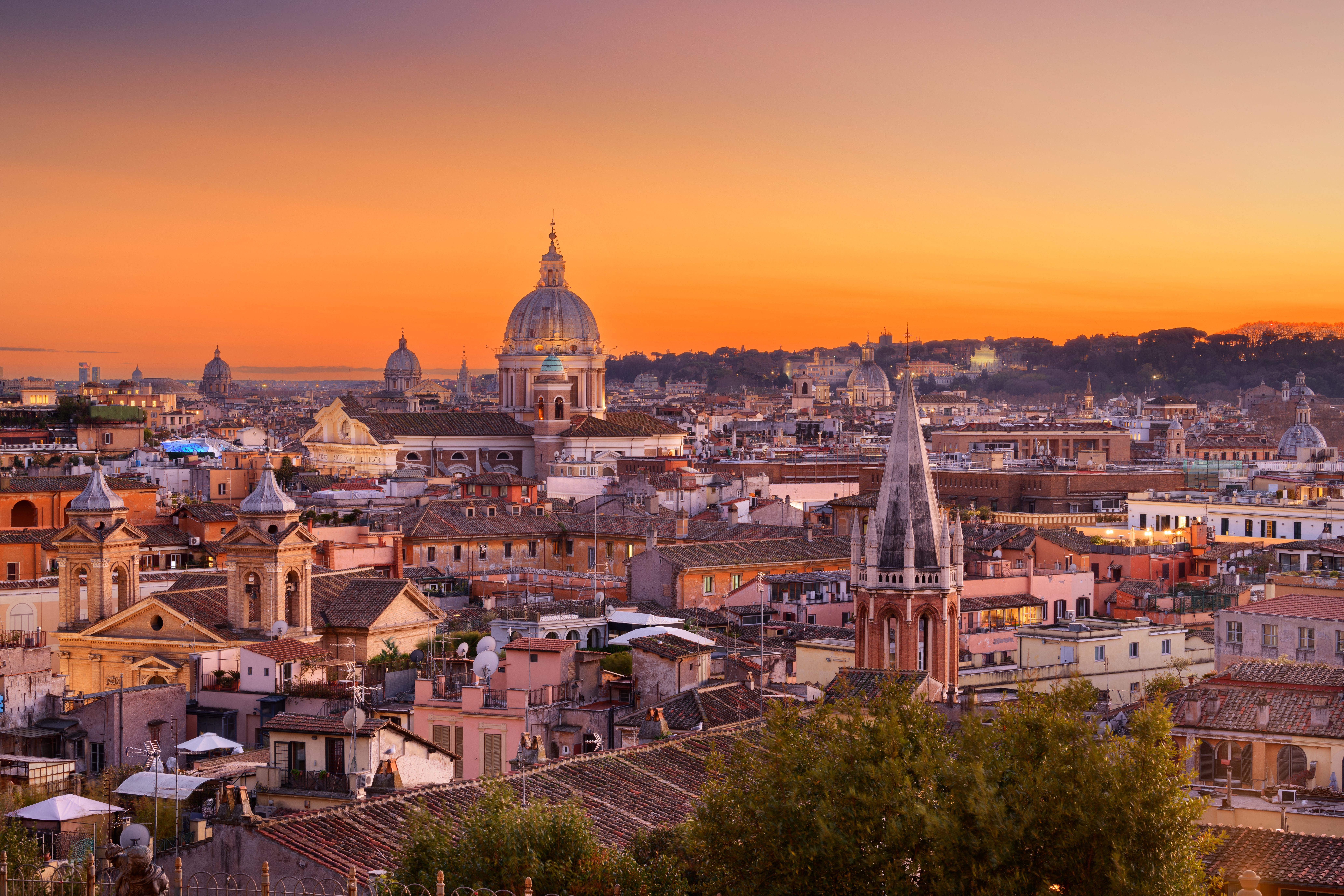 Aerial view across the cityscape of Rome, Italy at sunset